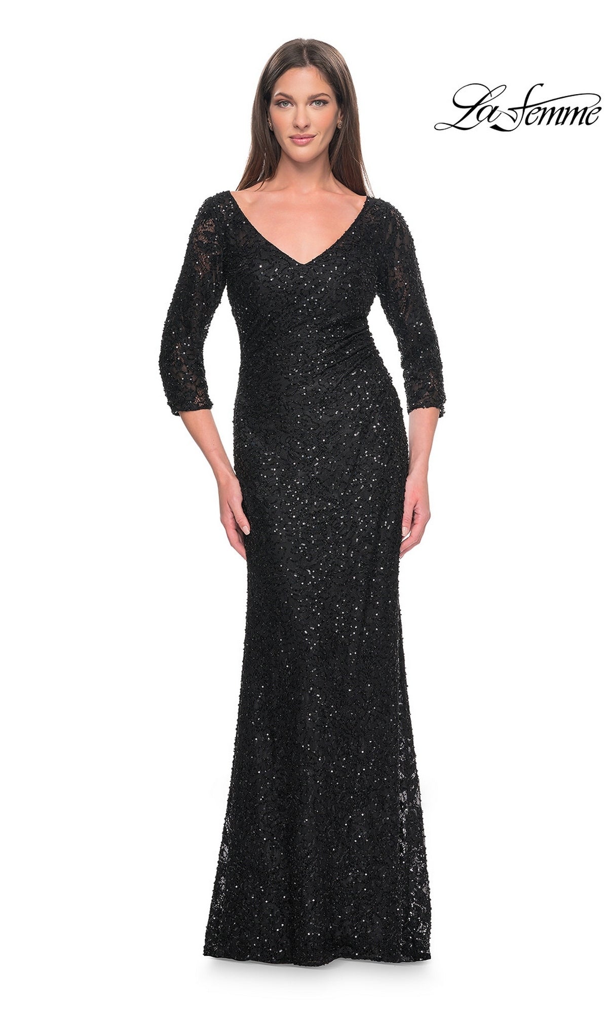 A woman wearing a black, long-sleeved, floor-length beaded lace Long Formal Dress: La Femme 31721 with a V-neckline.
